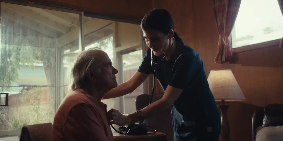 A footage of a lady treating an old man