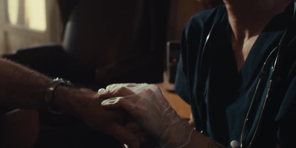 A nurse is rubbing a patients hand