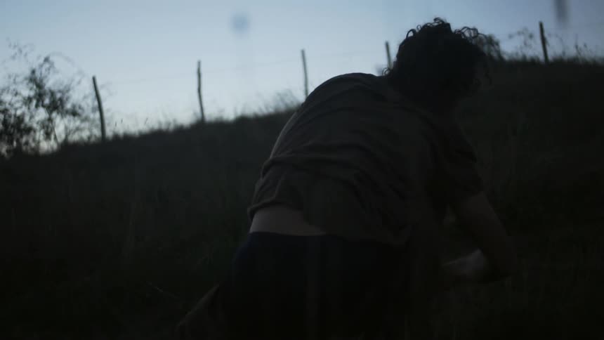 A man is walking uphill at dawn