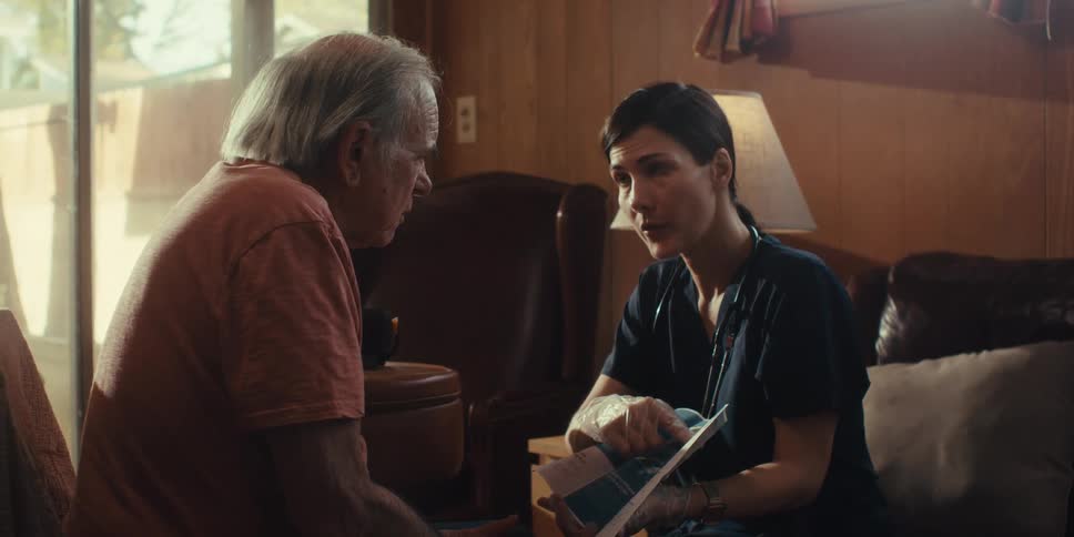 A footage of an elderly man having a conversation with a female doctor
