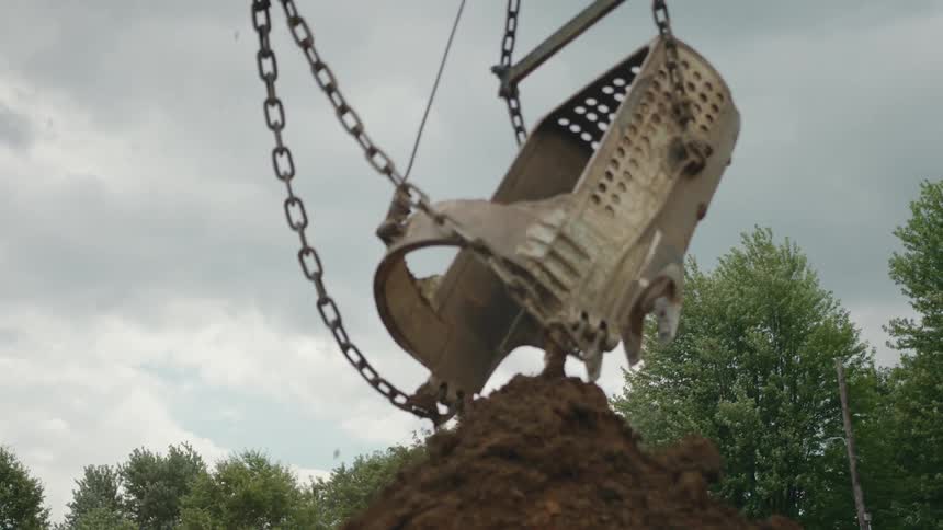 A container dumps dirt