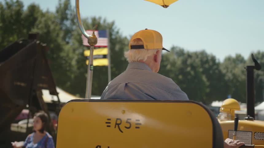 A footage of a man driving a tractor