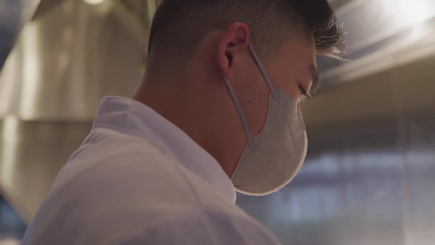 A man is wearing a mask inside
