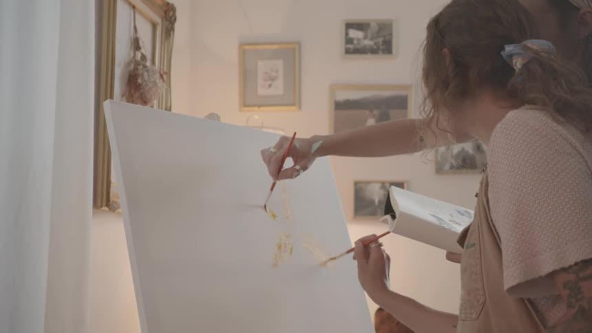 A footage of ladies painting on a canvas