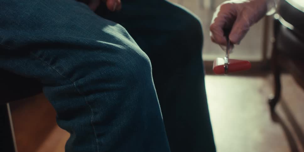A doctor is tending to a patient in their office