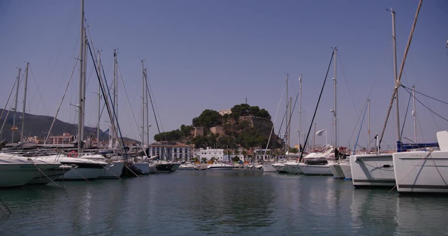 Sailboats docked in their slips on the harbor during the day
