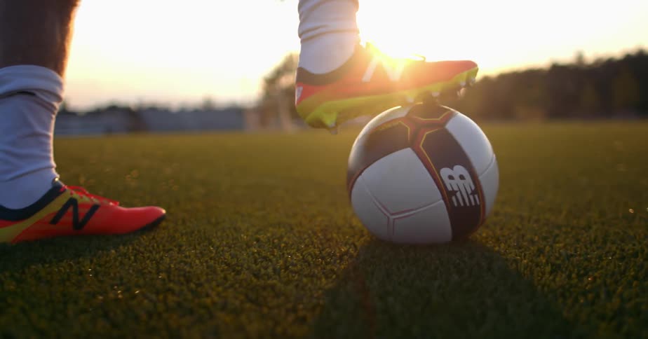 A soccer player kicks the ball around