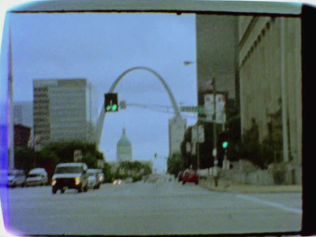 Cars drive on a city street
