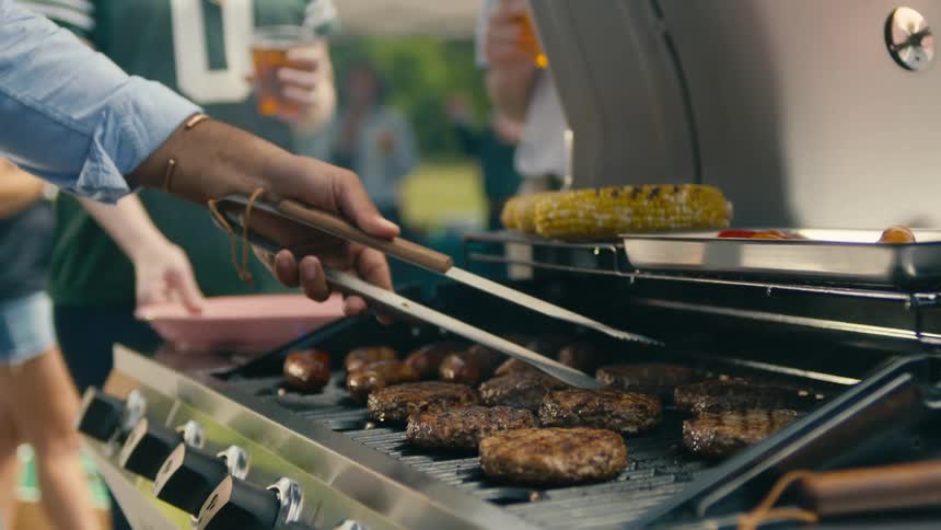 A man is grilling food outside