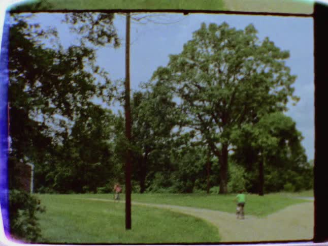 People are riding their bikes down a trail on a sunny day