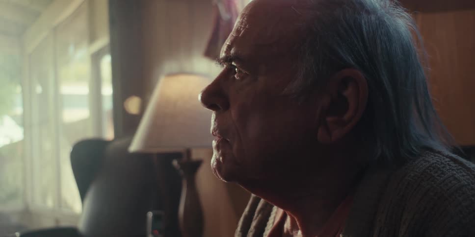Side portrait of an elderly man with a disbelieving expression while sitting in a living room