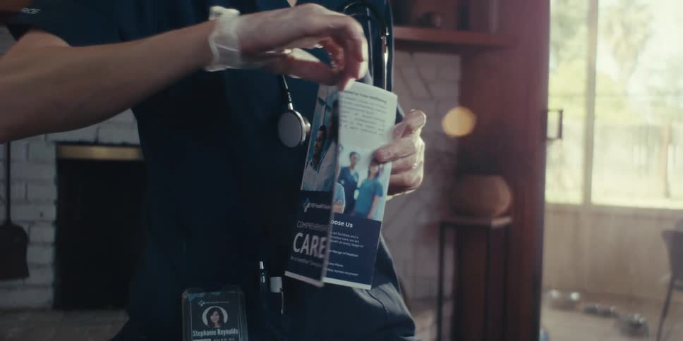 A nurse opens a brochure and talks
