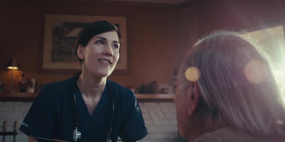 A nurse is talking with a patient at home