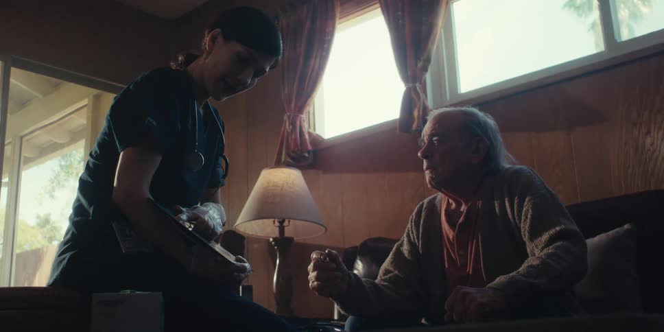 A footage of an elderly man and a doctor having a conversation