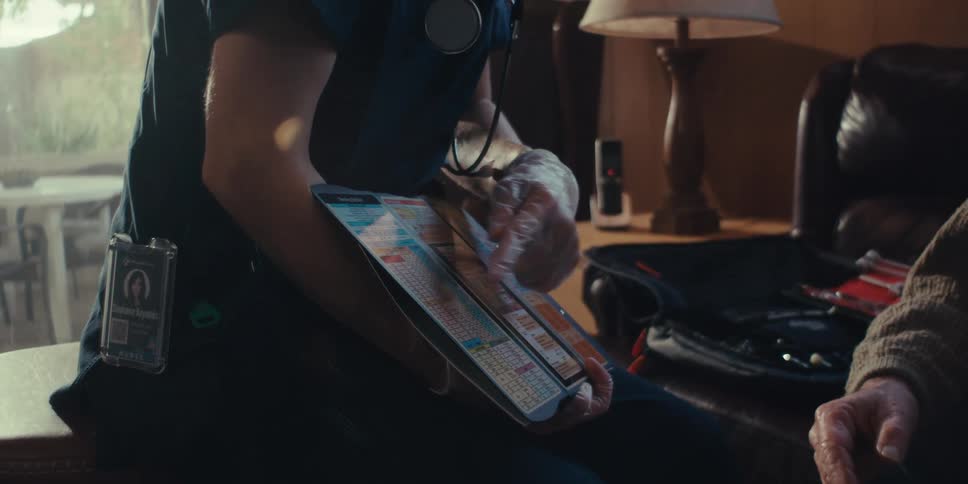 Young female nurse giving an explanation with exam papers in her hands