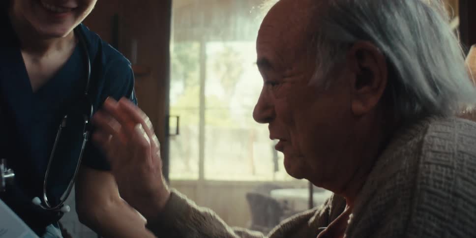 A footage of a female doctor and an elderly man exchanging conversations