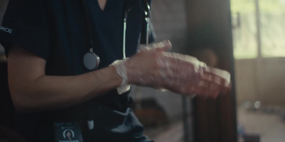 Close up of a nurses hands wearing clear disposable gloves making hand gestures