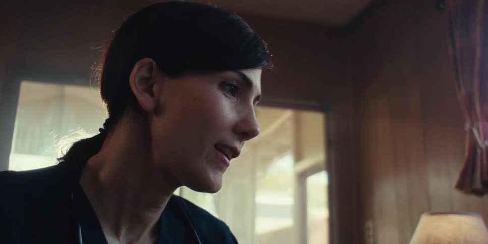 Side portrait of a young woman talking to another person