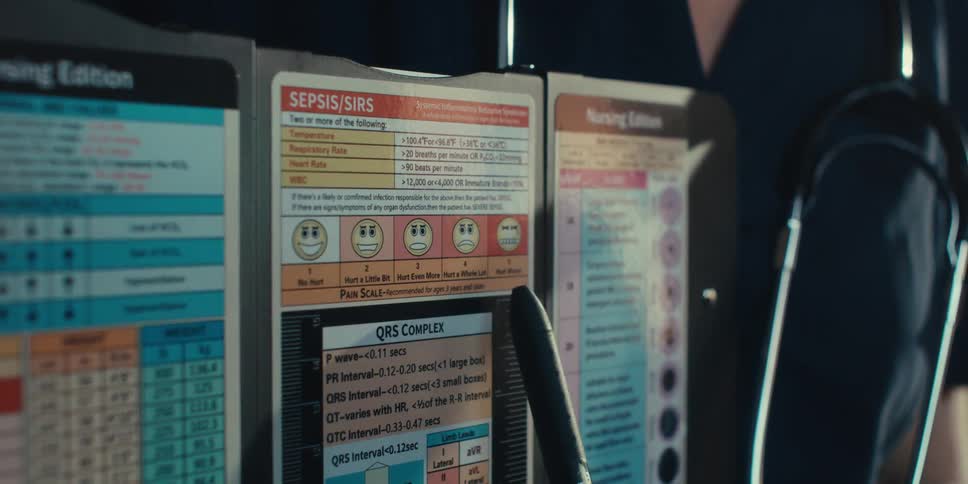 A doctor is pointing at a chart with their patient