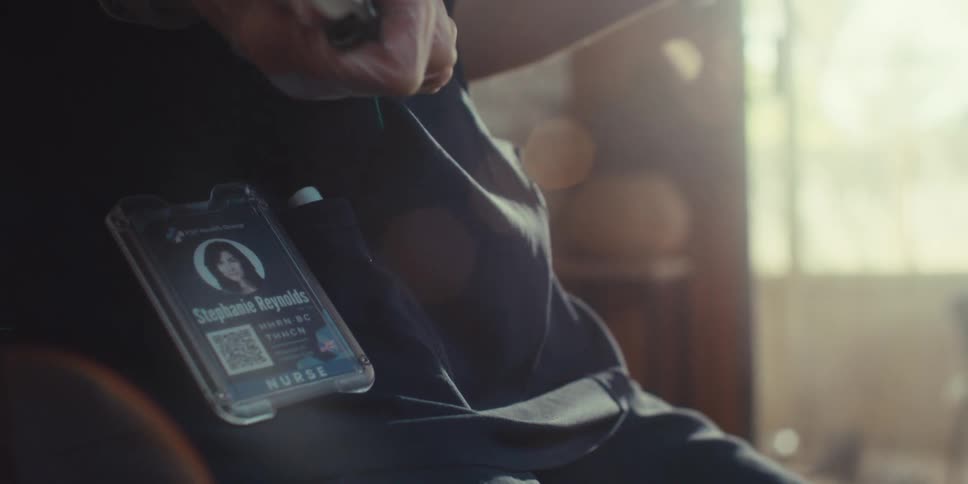 A footage of a person with an id card tag