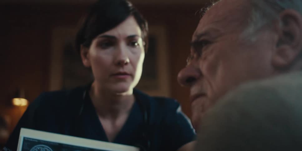 Nurse showing scans to an elderly man who is shaken