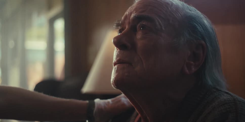 A footage of an elderly man crying indoor