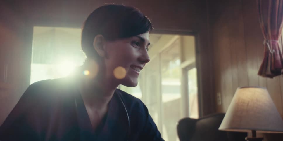 A nurse with a stethoscope tends to an patient at home
