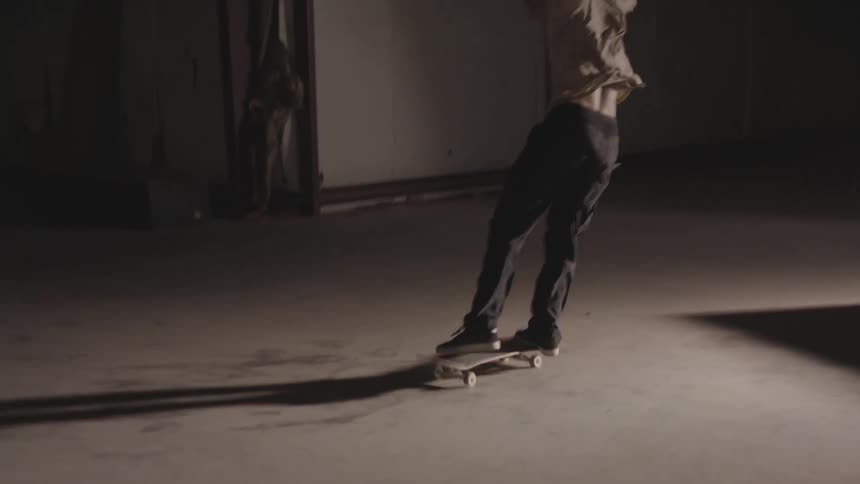 A male is practicing stunts on a skateboard