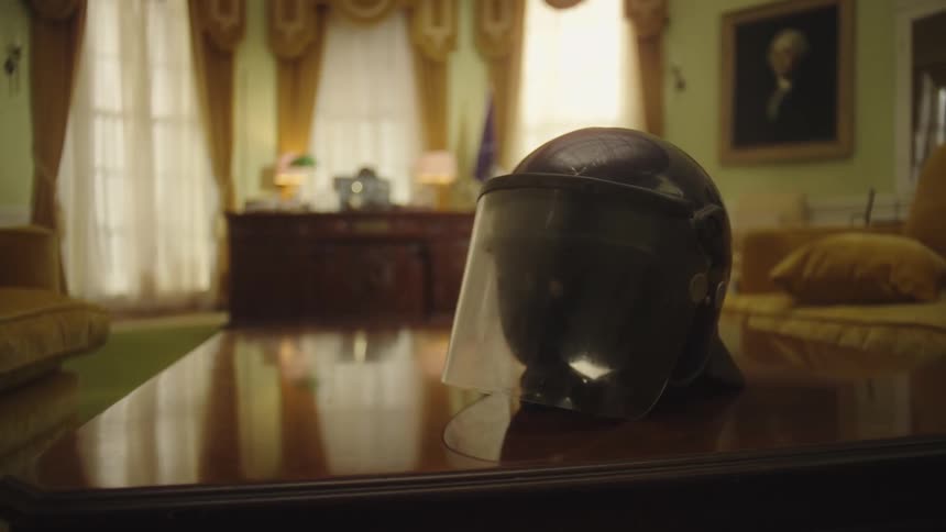 Riot gear helmet sits on a table in an elaborately decorated historic building