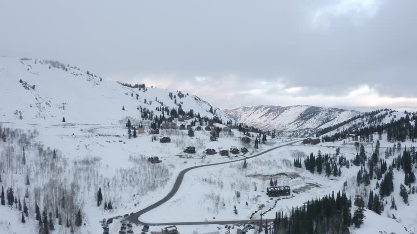 Aerial view of a runway in the middle of a snowy mountain