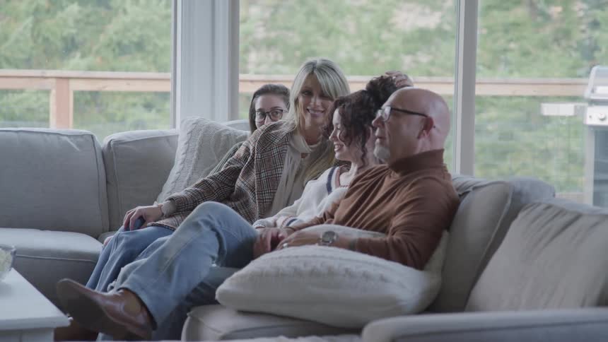 A family chats on the sofa