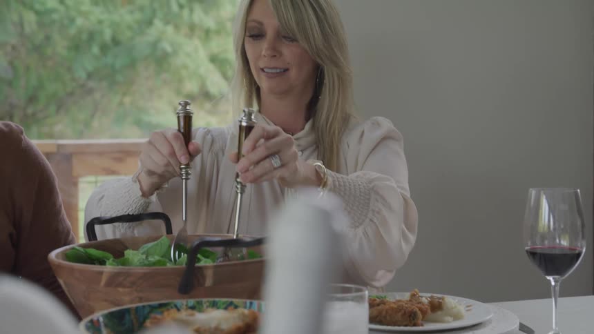 A family is eating dinner together at the table