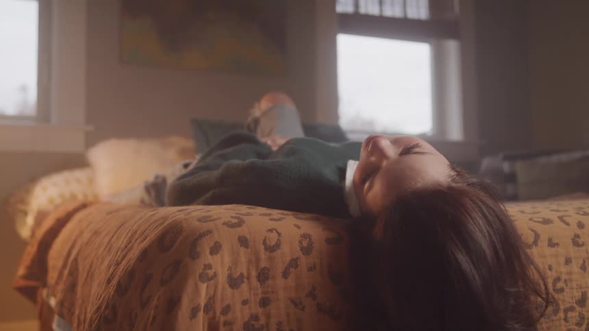 A woman lying on her bed