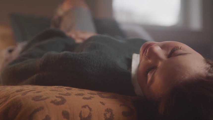 A woman lies on a bed