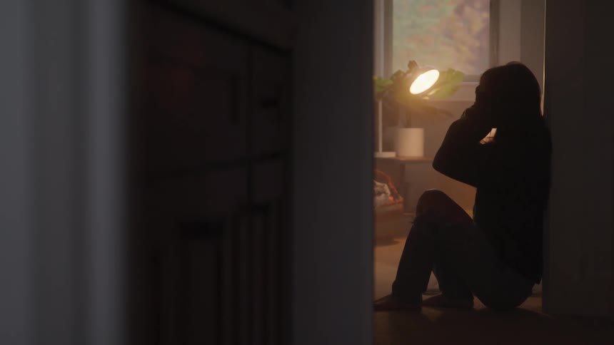 A person sinks to their knees in despair