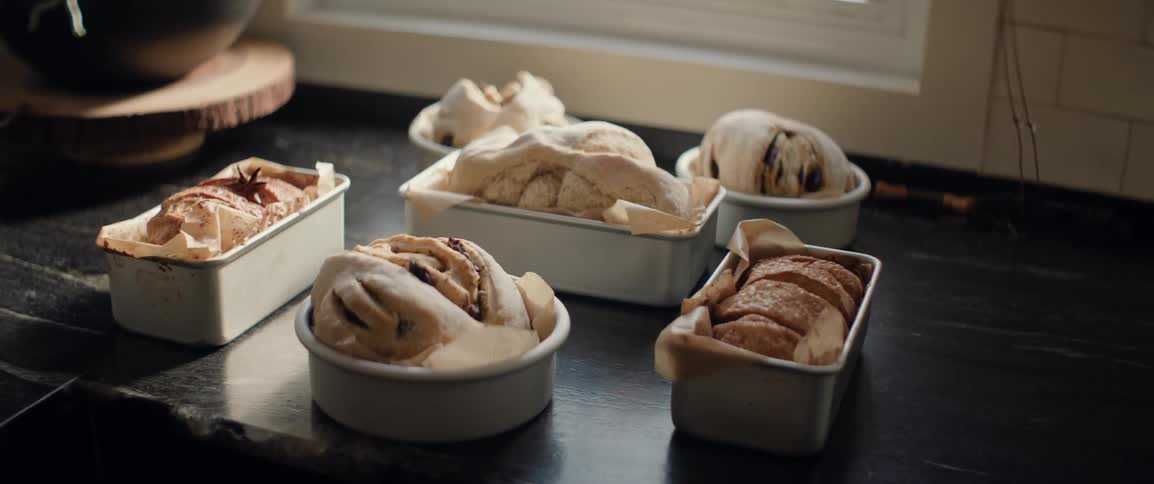 Bread and baked desserts are cooling off next to a window
