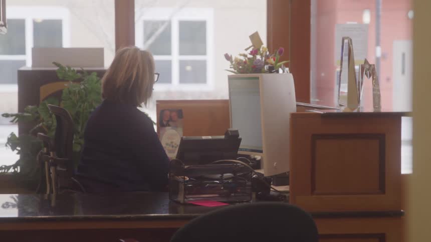 Woman sitting in an office works on a computer