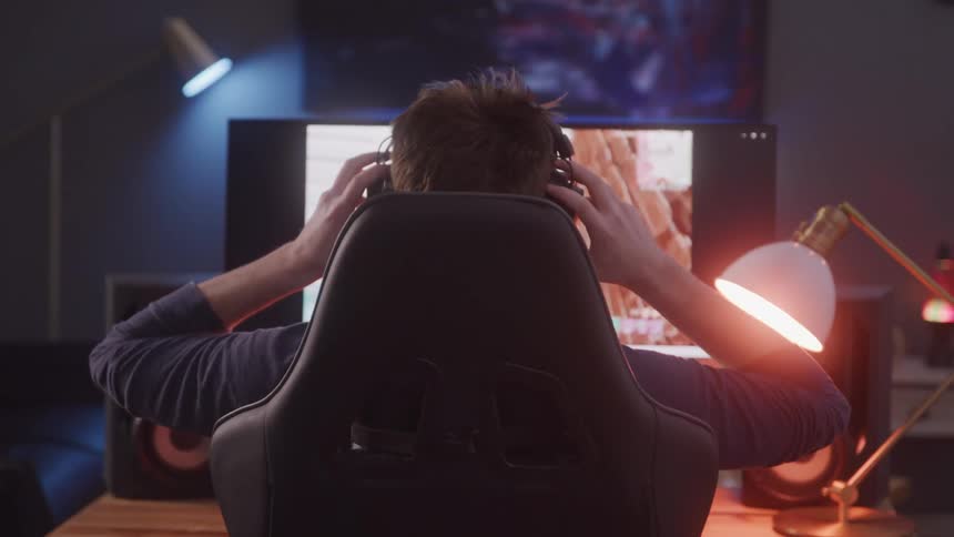 A footage of a male playing a game on the computer