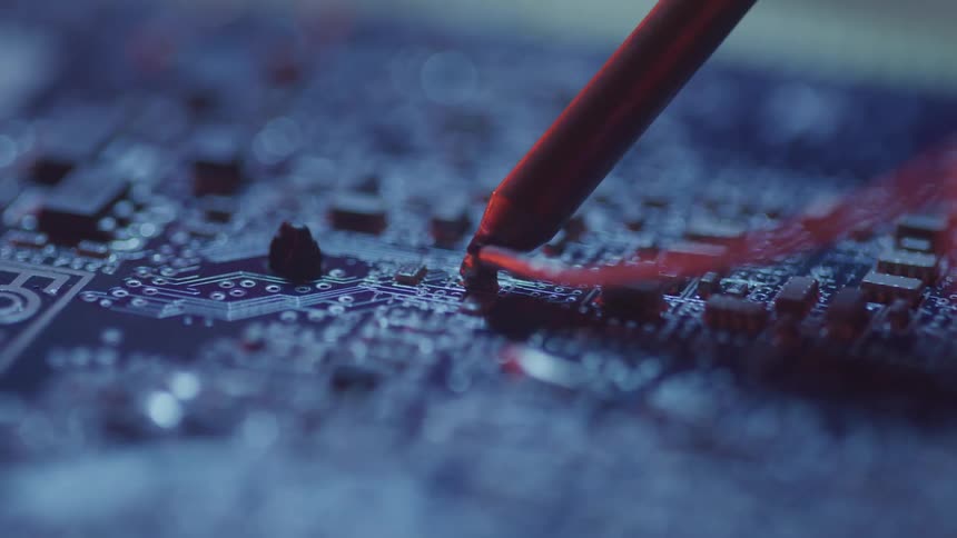 Close up of solder being applied to a circuit board