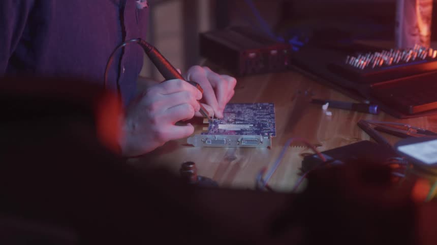 A footage of a person working on a video card