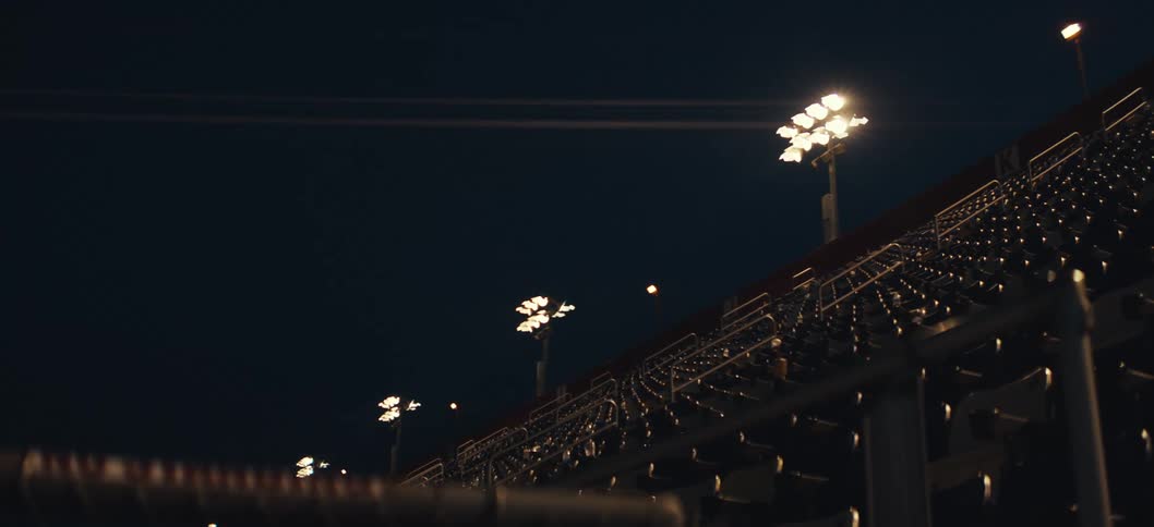 Empty grandstand at night and floodlights on