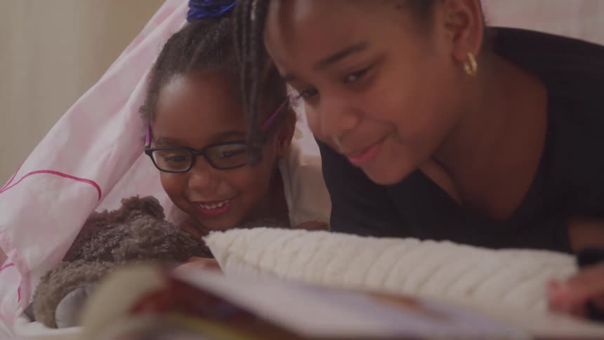 A footage of a mother studying with her daughter