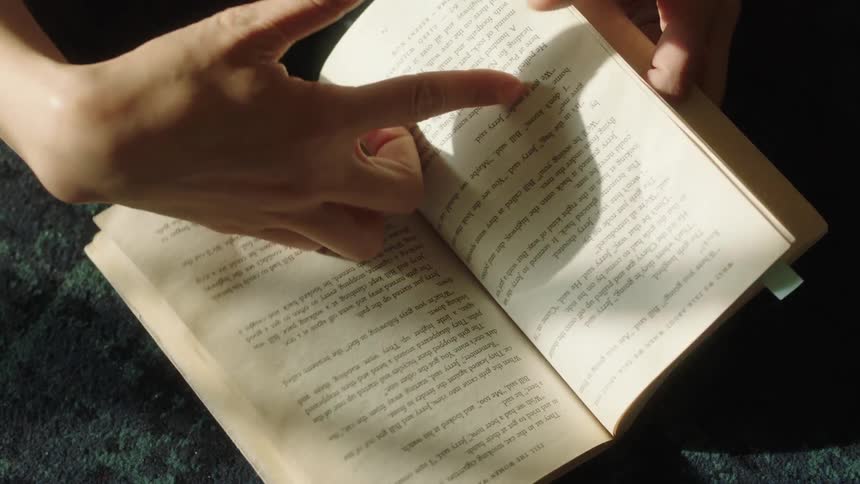 A footage of a person reading a book