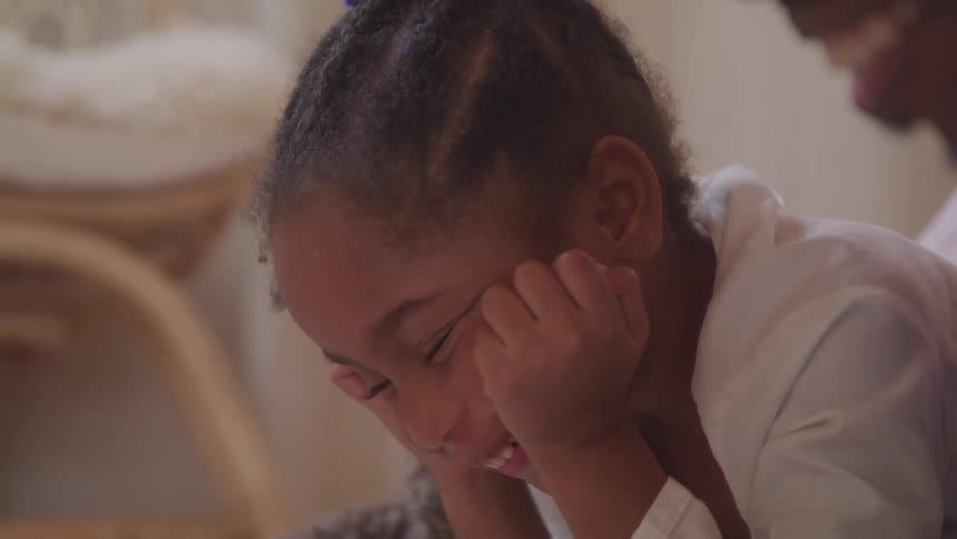 A child is laughing at home