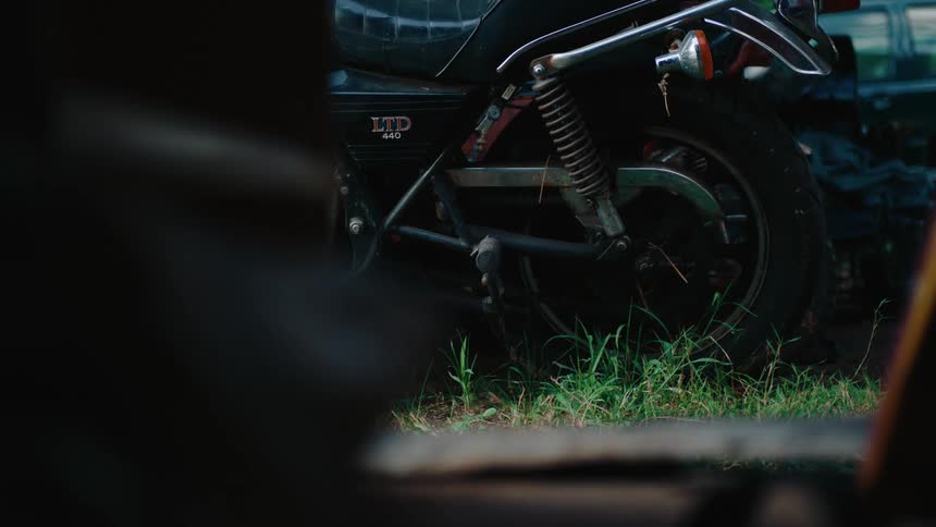 A motorcycle is parked in the grass