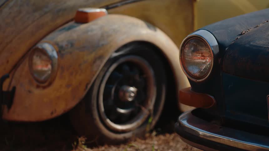 Vintage vehicles are parked in the sun