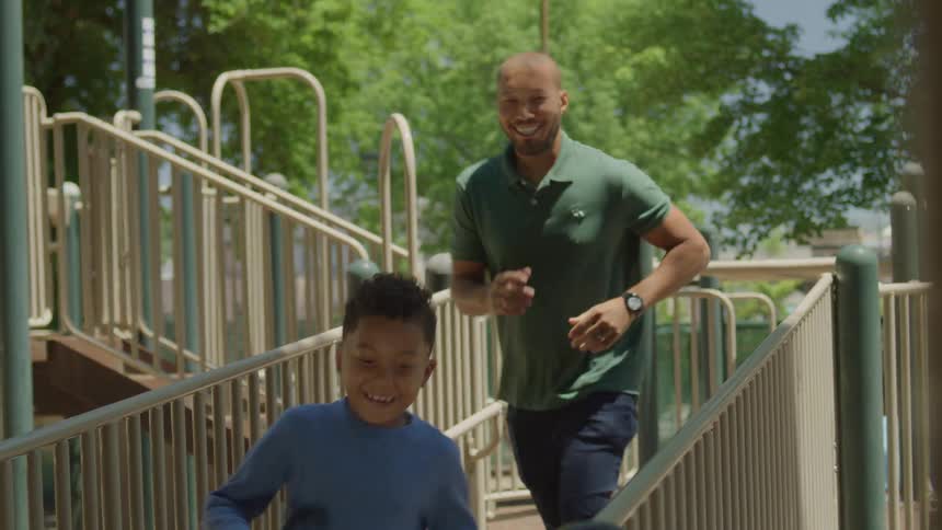 A man and his sun run in the park