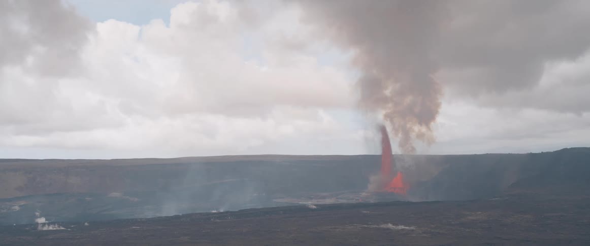 A volcano is shooting lava up into the air