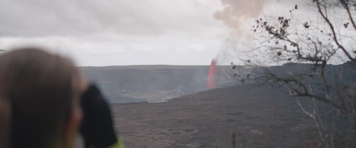The lava erupting causes smoke in the distance