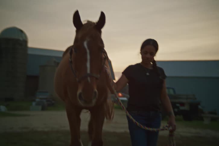 Woman walking next to a horse